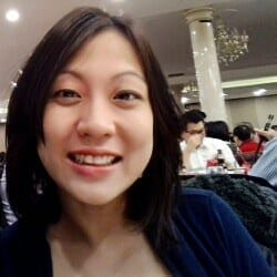 A woman smiling for the camera at a restaurant.